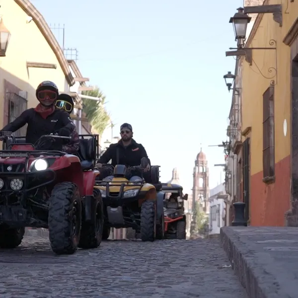 Guey Tours: ATV Tours and Convoy Riding through Atascadero A caravan of ATVs driving down a cobblestone street in Atascadero during a Guey Tours ATV Tours excursion.